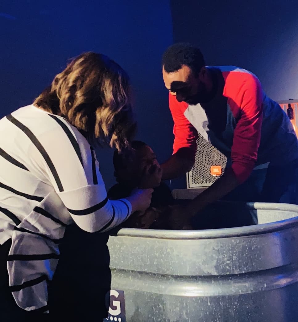 being lowered into water to be baptised