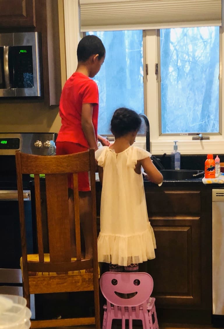 Kids cleaning at kitchen sink